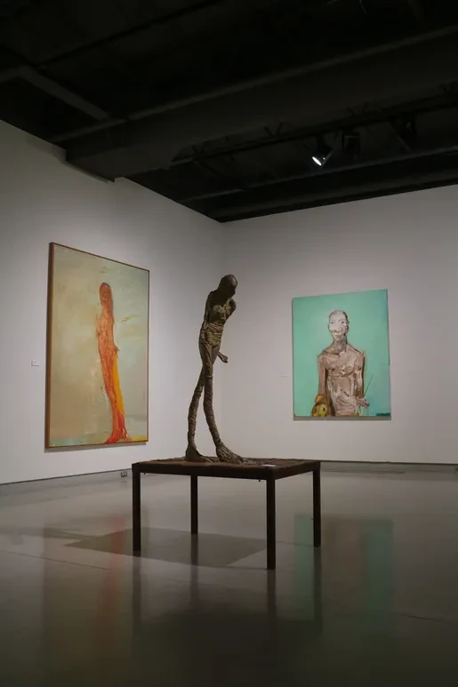 Fresno Art Museum — tall bronze figure with orange and teal figurative paintings