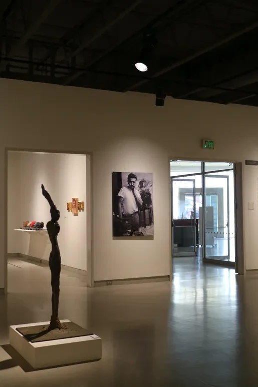 Fresno Art Museum — tall bronze figure reaching upward with large paintings