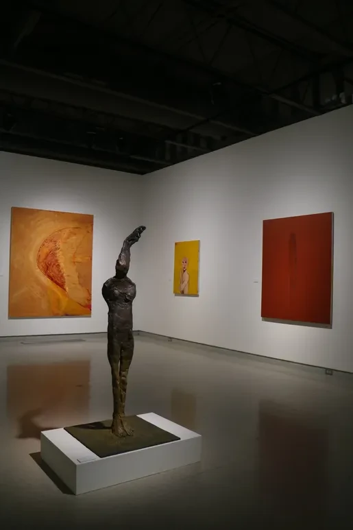 Fresno Art Museum — bronze figure sculpture with large orange and red canvases