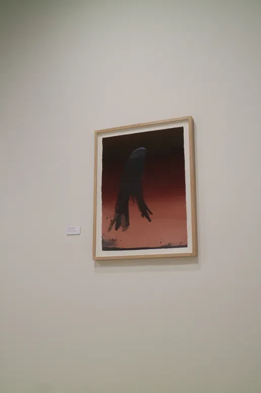 Fresno Art Museum — framed painting of dark silhouetted figure against deep red gradient