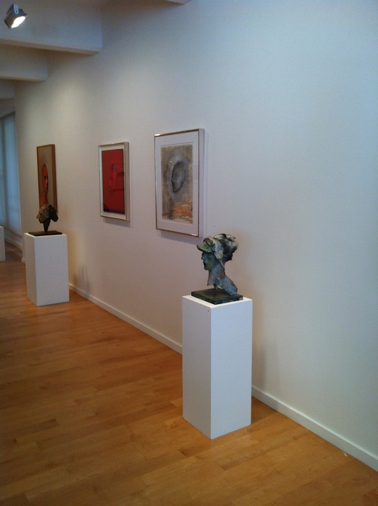 Berggruen Memorial Show — gallery corridor with bronze busts on pedestals and framed works