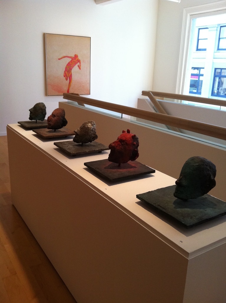 Berggruen Memorial Show — row of bronze head sculptures on display ledge