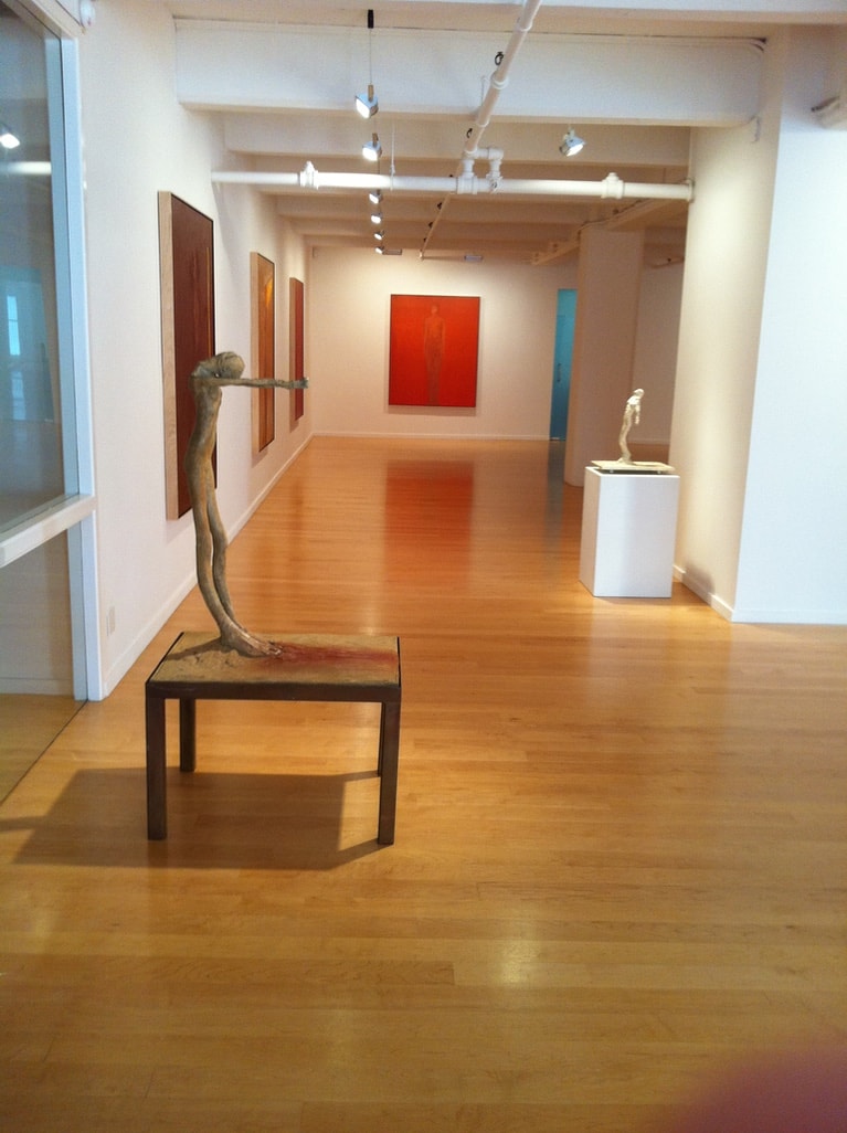 Berggruen Memorial Show — long gallery view with large red and orange canvases and bronze figures