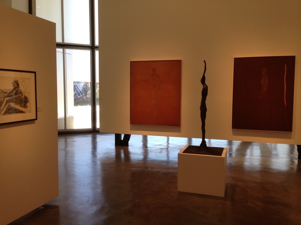 LewAllen Gallery — wide gallery view with two large red canvases and tall bronze figure sculpture