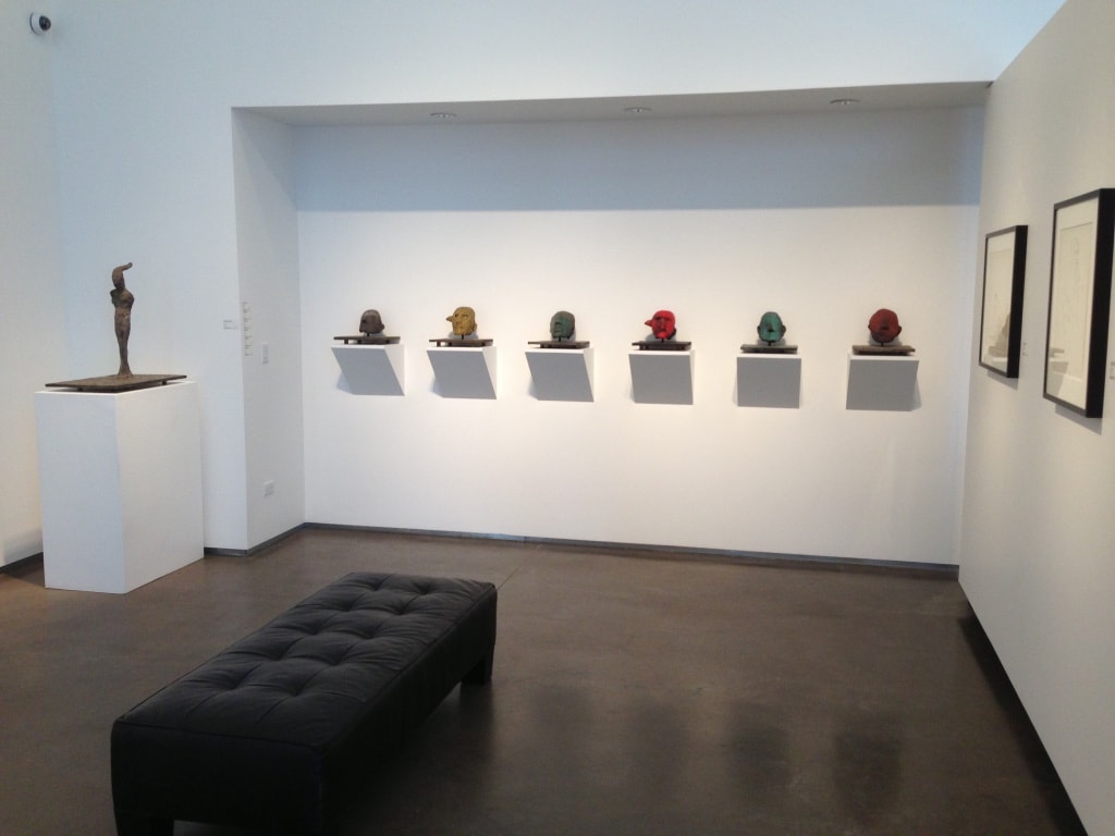 LewAllen Gallery — gallery room with six colorful sculptural heads on wall-mounted shelves