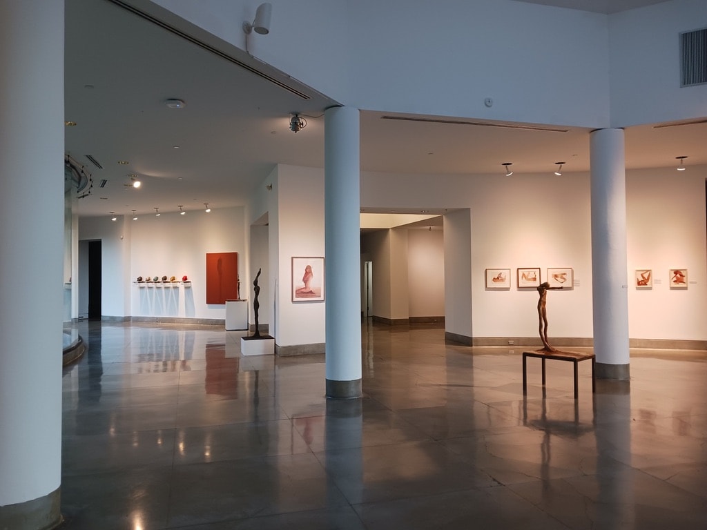 Triton Museum of Art — large gallery interior with sculptures and framed works on walls